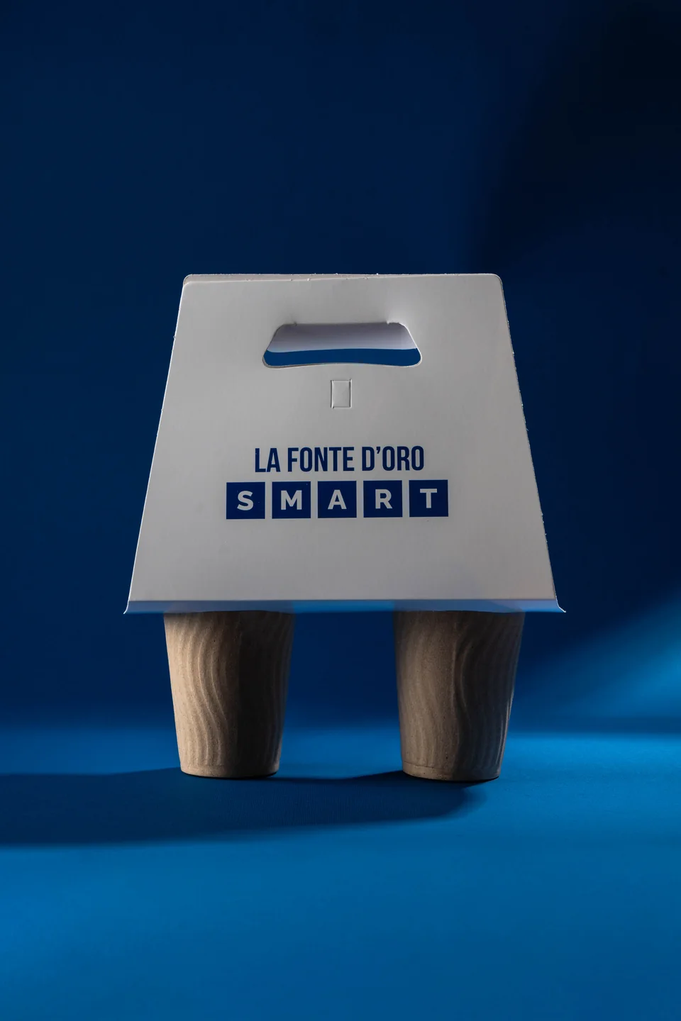 Vista frontal del portavasos La Fonte D’Oro SMART, con el nombre de la marca bajo el asa y dos vasos colocados.