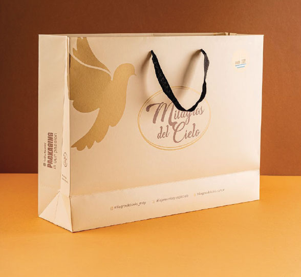 Bolsa de Milagros del Cielo con asas y gráfica en tonos dorados.